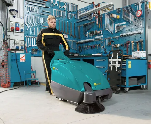 Walk-behind sweeper for cleaning mechanical workshop