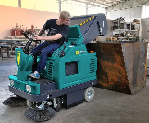 Extreme sweeper with elevated waste discharge system